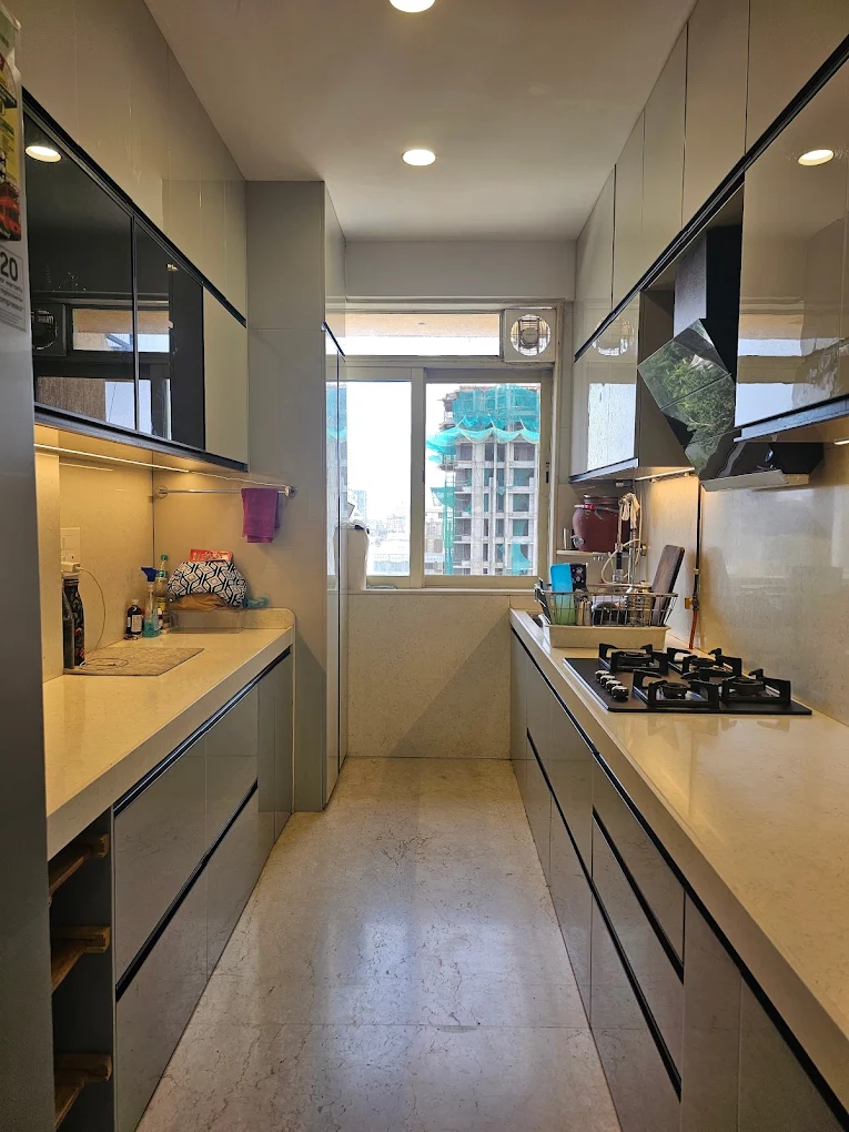 Parallel modular kitchen with glass shutters and quartz counters
